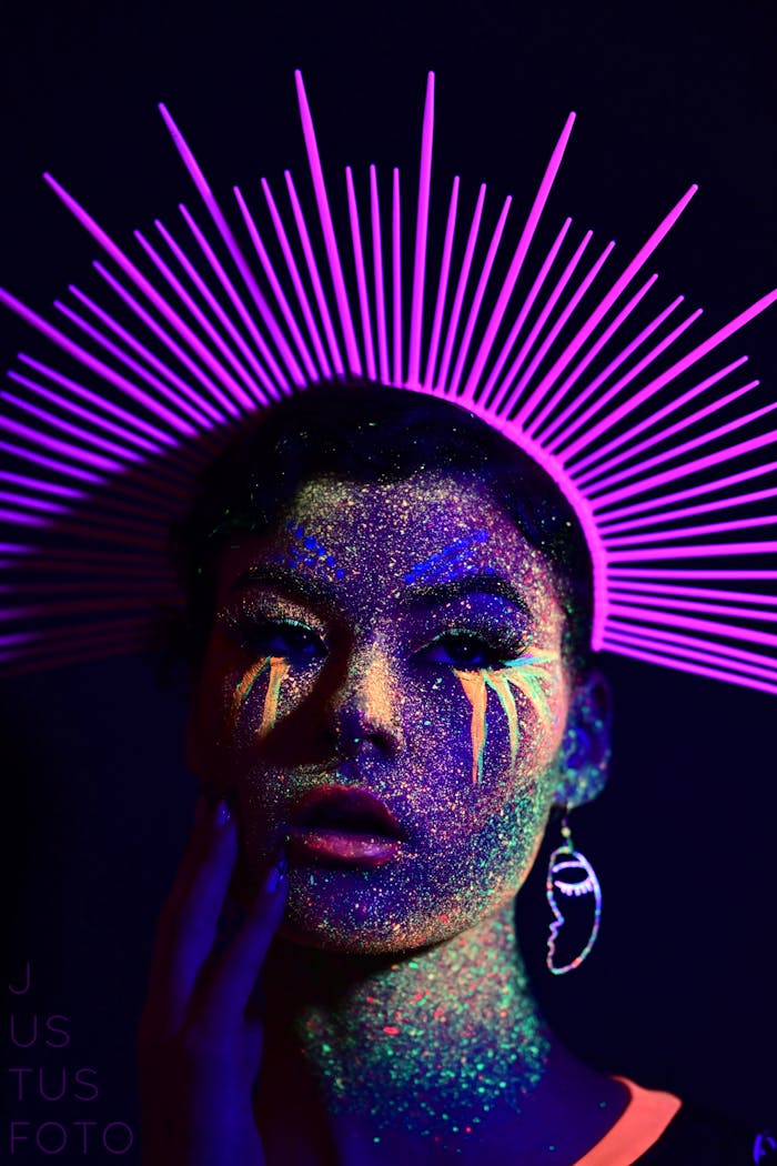 Dark Photo of a Woman in a Fluorescent Makeup and a Crown